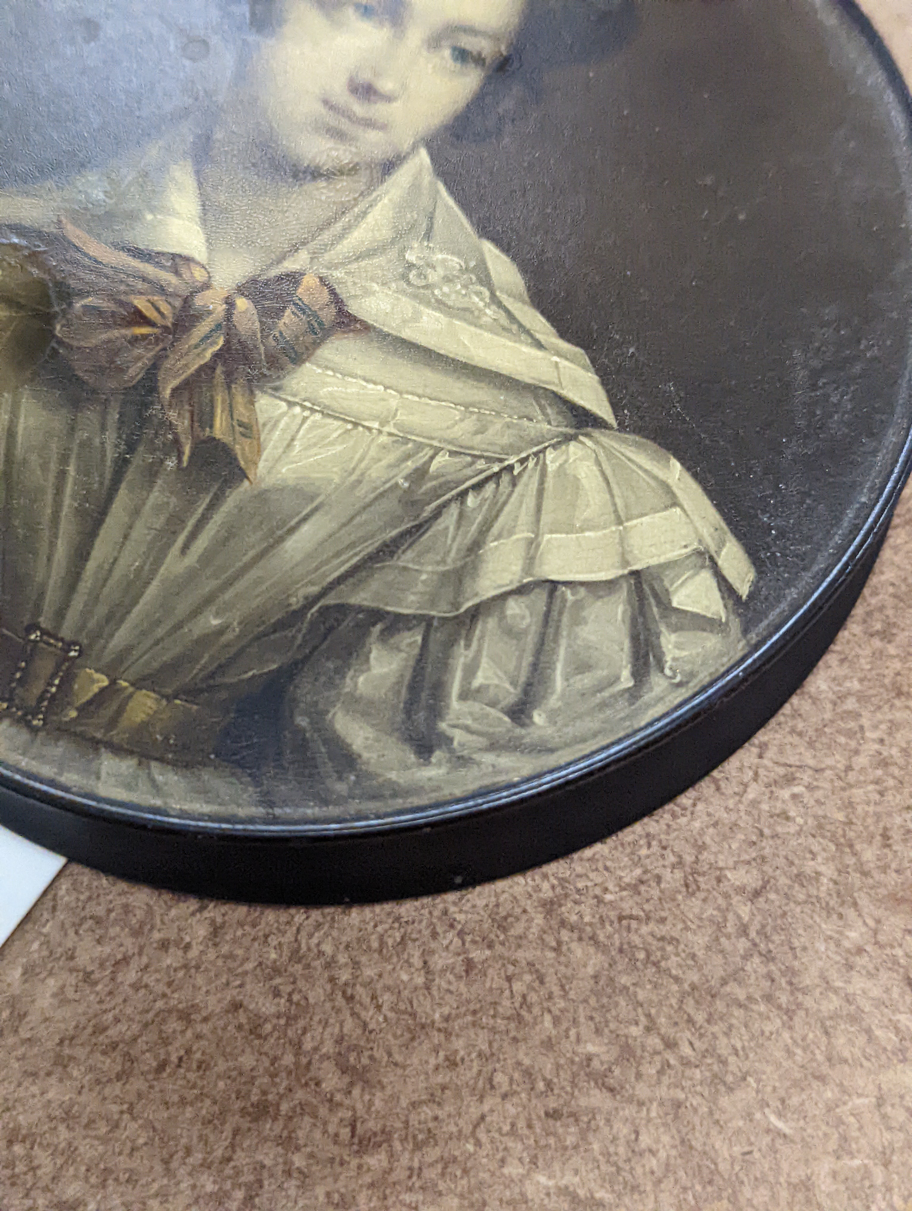 A 19th century Stobwasser papier mache ‘Henriette Sonntag’ portrait snuff box, c.1830, 9.7cm diameter and a 19th-century papier mache snuff box painted with a portrait of a German hussar, 9.4cm (2)